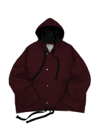 Wine red oversized hooded jacket with quilted lining and insulation.