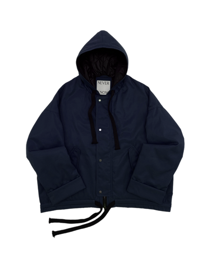 Navy oversized hooded jacket with quilted lining and insulation.