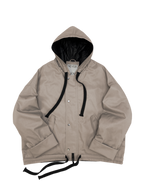 Beige oversized hooded jacket with quilted lining and insulation.