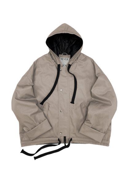 Beige oversized hooded jacket with quilted lining and insulation.